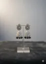 Silver-plated jhumka earrings with black stone